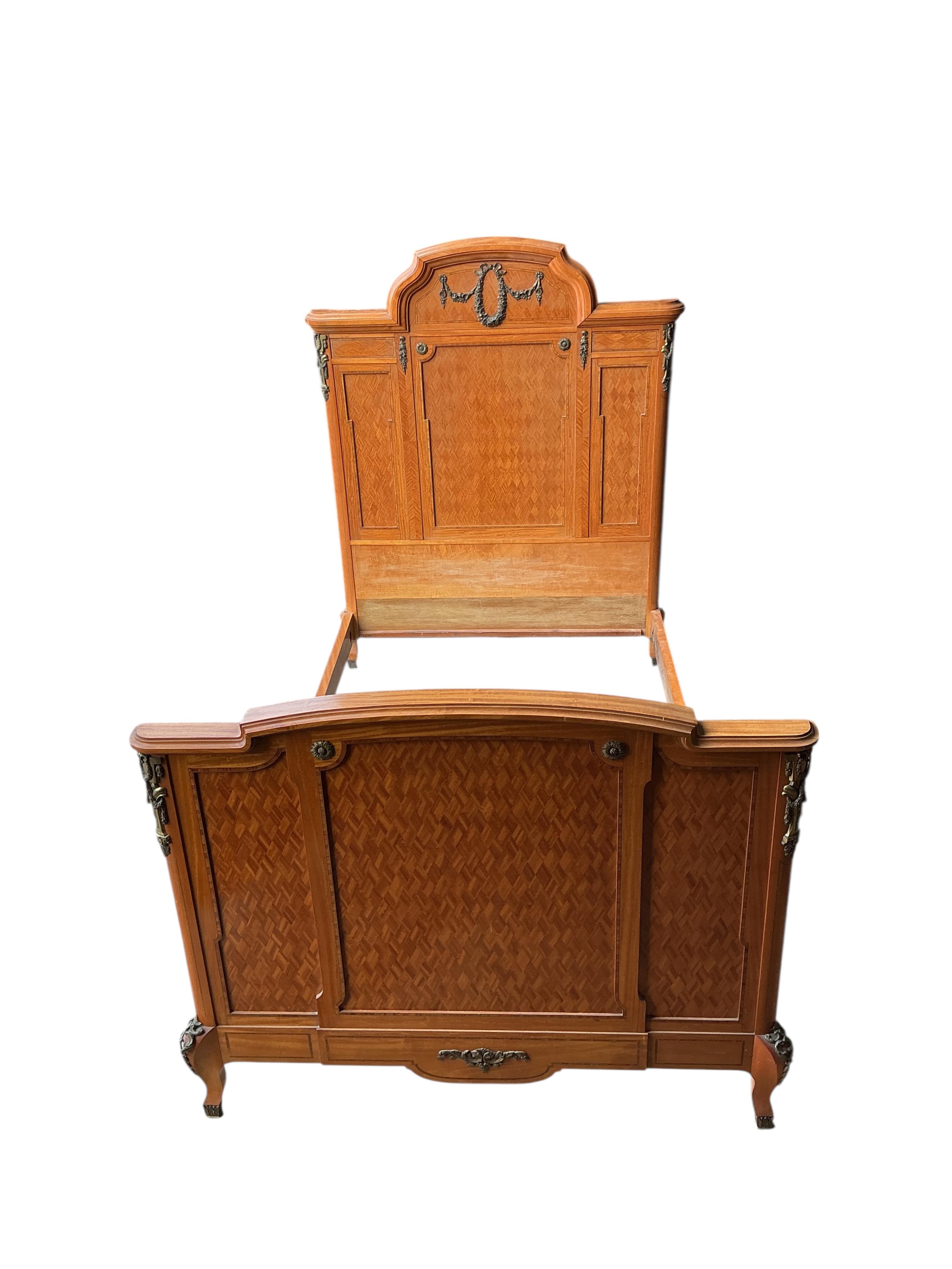 A pair of early 20th century French transitional style gilt metal mounted parquetry inlaid 4ft. bedframes, height 150cm